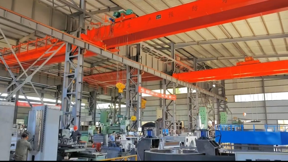 Factory overhead crane system, large industrial machinery and workers